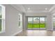 Bright living room with tile floors and sliding glass doors leading to a well-manicured backyard at 16234 Isola Pl, Bradenton, FL 34211