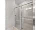 Modern shower with glass enclosure, tile surround, and a built-in bench for convenience at 16234 Isola Pl, Bradenton, FL 34211