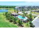 Aerial view of a community pool, golf course, lake, and condo buildings offering recreational opportunities at 18113 Gawthrop Drive # 101, Lakewood Ranch, FL 34211