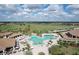 Stunning aerial view showcasing a resort-style pool, lush golf course, and beautiful homes in a vibrant community at 18113 Gawthrop Drive # 101, Lakewood Ranch, FL 34211