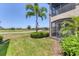 Inviting backyard with lush landscaping, screened porch, and golf course views, perfect for outdoor enjoyment at 18113 Gawthrop Drive # 101, Lakewood Ranch, FL 34211