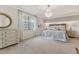 Serene bedroom with soft lighting, a decorative chandelier, and neutral decor at 18113 Gawthrop Drive # 101, Lakewood Ranch, FL 34211