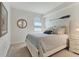 Cozy bedroom featuring neutral walls, a white bedframe, and nautical-themed decor at 18113 Gawthrop Drive # 101, Lakewood Ranch, FL 34211