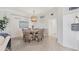 Cozy dining room with a round table, woven chairs, and a decorative chandelier at 18113 Gawthrop Drive # 101, Lakewood Ranch, FL 34211