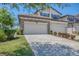 Charming home featuring a brick driveway, two-car garage, and manicured landscaping at 18113 Gawthrop Drive # 101, Lakewood Ranch, FL 34211