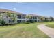 Charming multi-story condo featuring a well-maintained lawn, scenic pathway, and serene landscaping at 18113 Gawthrop Drive # 101, Lakewood Ranch, FL 34211