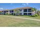 Attractive condos overlook a lush lawn with screened-in patios and balconies for outdoor comfort and relaxation at 18113 Gawthrop Drive # 101, Lakewood Ranch, FL 34211