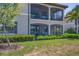 Beautiful exterior of a two-story home featuring screened-in patios and balconies, ideal for relaxation at 18113 Gawthrop Drive # 101, Lakewood Ranch, FL 34211