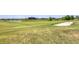 Scenic golf course view featuring manicured greens, a pond, and luxurious homes in the background at 18113 Gawthrop Drive # 101, Lakewood Ranch, FL 34211