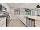 Bright kitchen featuring stainless steel appliances, a center island, and modern finishes at 18113 Gawthrop Drive # 101, Lakewood Ranch, FL 34211