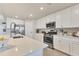 Modern kitchen with stainless steel appliances, quartz countertops, and ample cabinet space at 18113 Gawthrop Drive # 101, Lakewood Ranch, FL 34211