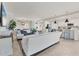 Bright open-concept living space with tile flooring, plush sofas, and modern lighting fixtures at 18113 Gawthrop Drive # 101, Lakewood Ranch, FL 34211