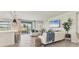 Bright and airy living room featuring neutral decor, tile floors, and sliding glass doors at 18113 Gawthrop Drive # 101, Lakewood Ranch, FL 34211