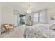 Bright main bedroom featuring a chandelier, balcony access, and an abundance of natural light at 18113 Gawthrop Drive # 101, Lakewood Ranch, FL 34211