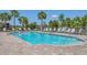 Sparkling community pool with shallow end, brick-paved surround, and lounge chairs for a resort-like experience at 18113 Gawthrop Drive # 101, Lakewood Ranch, FL 34211