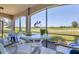 Screened porch overlooking a golf course featuring outdoor seating and furniture at 18113 Gawthrop Drive # 101, Lakewood Ranch, FL 34211