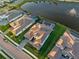 Aerial view of the luxurious home with a private pool, water feature, and lake view at 18215 Cayo Largo Pl, Bradenton, FL 34202