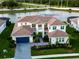 Stunning aerial view of a two-story home with well-manicured lawn and inviting outdoor space at 18215 Cayo Largo Pl, Bradenton, FL 34202