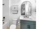 Stylish bathroom showcasing a green vanity and modern fixtures, with elegant wall paneling at 18215 Cayo Largo Pl, Bradenton, FL 34202