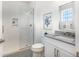 Modern bath with glass shower, geometric floor, and white vanity for a sleek design at 18215 Cayo Largo Pl, Bradenton, FL 34202