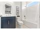 Bright bathroom featuring a navy vanity and modern fixtures for a clean, stylish design at 18215 Cayo Largo Pl, Bradenton, FL 34202