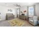 Bedroom design features carpet flooring, ceiling fan, two windows, a crib, and a dresser at 18215 Cayo Largo Pl, Bradenton, FL 34202