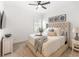 Serene bedroom showcasing a tufted headboard bed, neutral decor, and a ceiling fan at 18215 Cayo Largo Pl, Bradenton, FL 34202