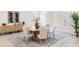 Elegant dining room with wood table, linen chairs, modern accents, and natural lighting at 18215 Cayo Largo Pl, Bradenton, FL 34202