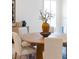 Close-up of dining table and chairs, showcasing natural light and decorative elements at 18215 Cayo Largo Pl, Bradenton, FL 34202