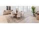 Elegant dining room with a round wooden table, stylish chairs, and bright natural light from shuttered windows at 18215 Cayo Largo Pl, Bradenton, FL 34202