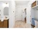 Inviting entryway with custom built-in storage, a half-bath, and light, neutral flooring at 18215 Cayo Largo Pl, Bradenton, FL 34202