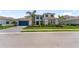 Beautiful two-story home with a well-manicured lawn, lush tropical landscaping and a paver driveway at 18215 Cayo Largo Pl, Bradenton, FL 34202