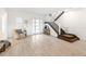 Bright foyer with wood-look tile floors, a white staircase, and a modern front door, offering a welcoming entrance at 18215 Cayo Largo Pl, Bradenton, FL 34202