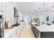 Spacious kitchen featuring white cabinets, a large island, and an open layout to the dining area at 18215 Cayo Largo Pl, Bradenton, FL 34202