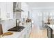 Modern kitchen with white cabinetry, stainless steel appliances, and a view to the breakfast area at 18215 Cayo Largo Pl, Bradenton, FL 34202
