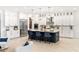 Bright kitchen featuring a large center island, stainless steel appliances, and stylish pendant lighting at 18215 Cayo Largo Pl, Bradenton, FL 34202
