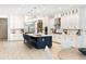 White and navy kitchen featuring a large center island and stainless steel appliances at 18215 Cayo Largo Pl, Bradenton, FL 34202
