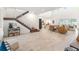 Expansive living room with soaring ceilings, wood-look tile flooring, and an open layout offering serene water views at 18215 Cayo Largo Pl, Bradenton, FL 34202