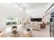 Bright living area featuring expansive sliding glass doors, built-in shelving, and contemporary decor at 18215 Cayo Largo Pl, Bradenton, FL 34202