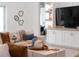 Inviting living room with cozy seating, stylish decor, built-in shelving, and a glimpse of the bedroom at 18215 Cayo Largo Pl, Bradenton, FL 34202