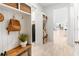 Functional mudroom with built-in bench, storage, and organizational features at 18215 Cayo Largo Pl, Bradenton, FL 34202