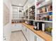 Walk-in pantry featuring custom shelving and ample storage space at 18215 Cayo Largo Pl, Bradenton, FL 34202