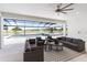 Gorgeous covered patio with upscale furnishings and a view of the beautiful pool and lake at 18215 Cayo Largo Pl, Bradenton, FL 34202