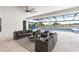 Screened patio with outdoor living area, overlooking the pool, lake, and play structure at 18215 Cayo Largo Pl, Bradenton, FL 34202