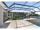 Backyard featuring an enclosed pool and a play area with a slide and playhouse at 18215 Cayo Largo Pl, Bradenton, FL 34202