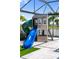 Close up of playhouse on an artificial lawn, adjacent to the pool's screened enclosure at 18215 Cayo Largo Pl, Bradenton, FL 34202