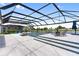 Beautiful in-ground pool with water features and a screened enclosure, overlooking a tranquil lake at 18215 Cayo Largo Pl, Bradenton, FL 34202