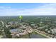 Aerial view of the neighborhood showcasing lush greenery, nearby lakes, and well-spaced homes at 2141 Cork Oak St, Sarasota, FL 34232
