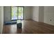 Bright bedroom with new flooring, sliding glass door, and fresh paint ready for personalization at 2141 Cork Oak St, Sarasota, FL 34232