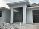 New construction modern home exterior featuring a front-entry design and an attached, two-car garage at 2141 Cork Oak St, Sarasota, FL 34232